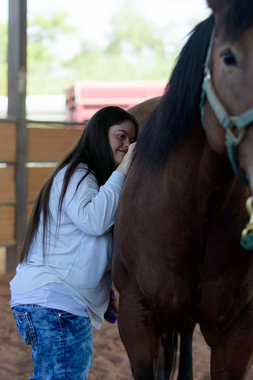 Girl hugging horse