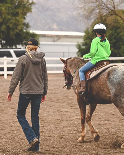 Woman and child riding horse